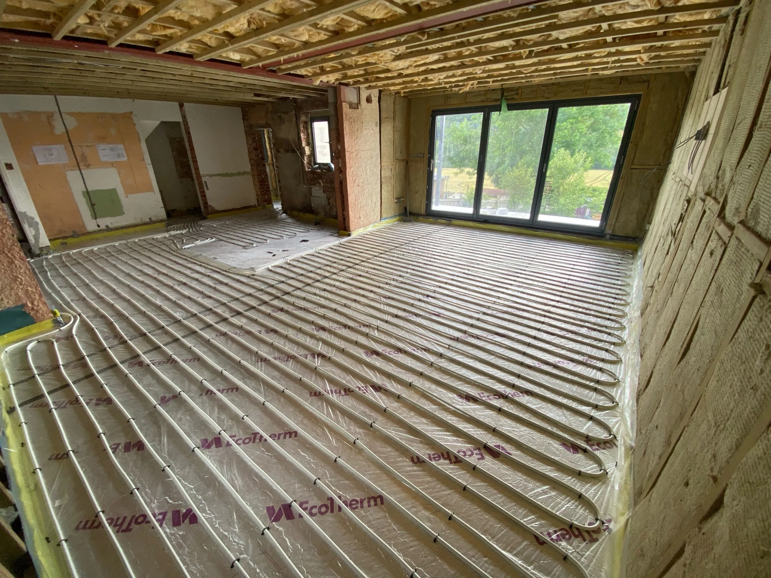 Underfloor heating pipes clipped to insulation at 150mm centres.